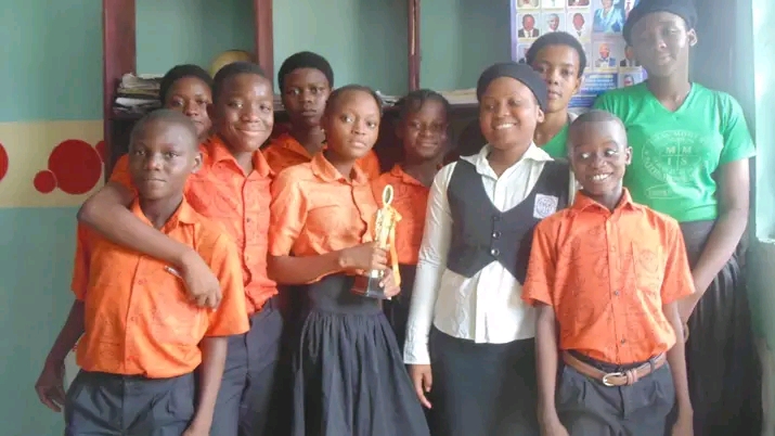 A teacher helping a student with a digital learning device.